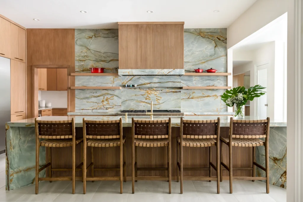 Warm wood kitchen with dramatic stone backsplash and bar seating in the Walnut Hill remodel