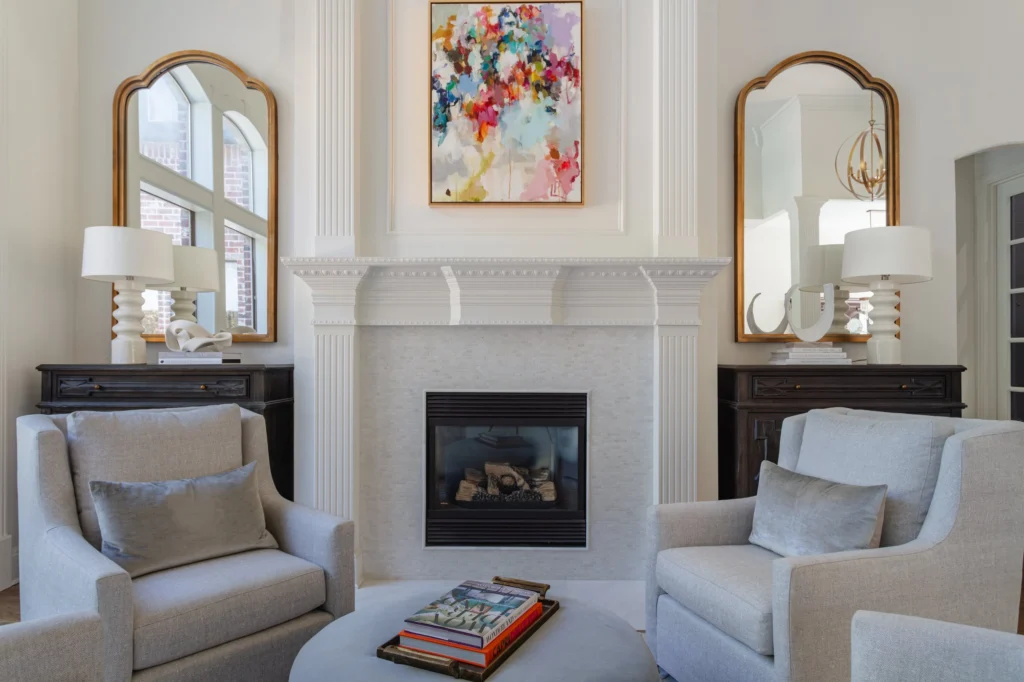 Formal living room with fireplace, artwork, and arched mirrors in the Park Place I remodel